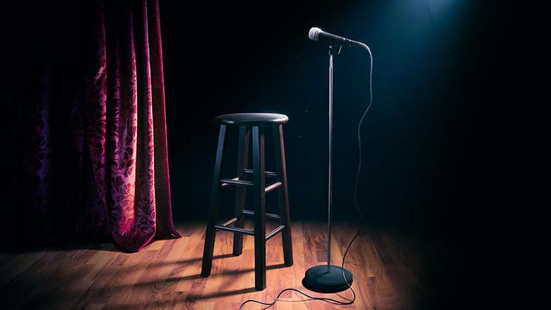 A microphone and stool for a stand-up comedy performance